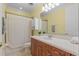 Well-lit bathroom with wooden cabinets and a shower-tub combination at 8476 Dunham Station Dr, Tampa, FL 33647