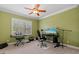Neutral-toned bedroom featuring a ceiling fan and plantation shutters at 8476 Dunham Station Dr, Tampa, FL 33647