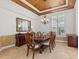 Dining room with tray ceiling, chandelier, and large window at 8476 Dunham Station Dr, Tampa, FL 33647