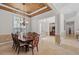 Elegant dining room featuring a tray ceiling, chandelier lighting and tile flooring at 8476 Dunham Station Dr, Tampa, FL 33647