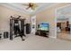 Exercise room with complete machine set, neutral color, and a large tv at 8476 Dunham Station Dr, Tampa, FL 33647