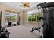 Home gym with exercise equipment and view of the pool and landscaped yard at 8476 Dunham Station Dr, Tampa, FL 33647