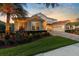 Elegant house featuring professional landscaping, a brick driveway, and a terracotta roof at 8476 Dunham Station Dr, Tampa, FL 33647