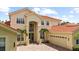 Impressive home exterior with a tile roof, manicured landscaping, and a grand entrance, reflecting luxury living at 8476 Dunham Station Dr, Tampa, FL 33647