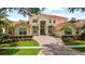 Stunning home exterior featuring a tile roof, manicured landscaping, and a welcoming circular driveway at 8476 Dunham Station Dr, Tampa, FL 33647