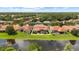Exterior photo showcases a luxurious home with a screened pool and landscaping, close to a scenic lake at 8476 Dunham Station Dr, Tampa, FL 33647