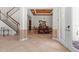 Foyer area leading to dining room and staircase with neutral color scheme and tile flooring at 8476 Dunham Station Dr, Tampa, FL 33647