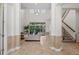 Bright foyer with soaring ceilings, tile flooring, staircase and open floor plan at 8476 Dunham Station Dr, Tampa, FL 33647