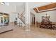 Open-concept area featuring tile flooring, neutral color scheme, dining room and staircase at 8476 Dunham Station Dr, Tampa, FL 33647