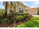 Beautiful house featuring professional landscaping, a terracotta roof and green lawn at 8476 Dunham Station Dr, Tampa, FL 33647