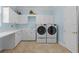 Bright laundry room with modern appliances and plenty of storage at 8476 Dunham Station Dr, Tampa, FL 33647