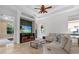 Open living room with large tv and decorative ceiling fan at 8476 Dunham Station Dr, Tampa, FL 33647