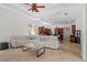 Bright living room with coffered ceilings and tile floors open to the kitchen with ample seating at 8476 Dunham Station Dr, Tampa, FL 33647
