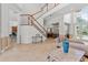 Open living room with staircase and view into dining room at 8476 Dunham Station Dr, Tampa, FL 33647