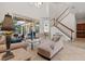 Bright living room features sliding glass doors and staircase at 8476 Dunham Station Dr, Tampa, FL 33647