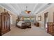 Spacious main bedroom with tray ceiling and wooden furniture at 8476 Dunham Station Dr, Tampa, FL 33647