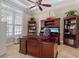 Beautiful office featuring custom cabinetry, large desk, and ample natural light at 8476 Dunham Station Dr, Tampa, FL 33647