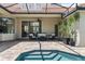 Covered patio with outdoor seating overlooks the screened pool at 8476 Dunham Station Dr, Tampa, FL 33647