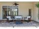 Patio seating area with a ceiling fan is perfect for relaxing by the pool at 8476 Dunham Station Dr, Tampa, FL 33647
