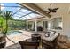 Enjoy this beautiful covered patio with custom brickwork and a large pool overlooking a lush green yard at 8476 Dunham Station Dr, Tampa, FL 33647