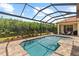 Landscaped screened-in pool overlooks a lush conservation area at 8476 Dunham Station Dr, Tampa, FL 33647