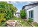 Backyard featuring lush tropical landscaping and a brick fire pit at 8635 Chadwick Dr, Tampa, FL 33635