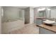 Bathroom with a shower, bathtub, double sinks, and granite counters at 8635 Chadwick Dr, Tampa, FL 33635