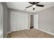Bedroom with closet, ceiling fan, neutral paint, and carpet at 8635 Chadwick Dr, Tampa, FL 33635