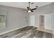 Bedroom with wood floors, ceiling fan, neutral paint and trim, closet, and attached bathroom at 8635 Chadwick Dr, Tampa, FL 33635