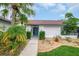 Charming front exterior with a blue front door and well-maintained landscaping, inviting curb appeal at 8635 Chadwick Dr, Tampa, FL 33635