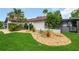 Beautiful home exterior with a well-manicured lawn and decorative rock garden at 8635 Chadwick Dr, Tampa, FL 33635