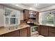 Close up of kitchen stainless appliances, wood cabinets, and mosaic backsplash at 8635 Chadwick Dr, Tampa, FL 33635