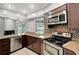Modern kitchen featuring granite countertops, stainless steel appliances, and dishwasher at 8635 Chadwick Dr, Tampa, FL 33635
