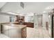 Spacious kitchen boasts stainless appliances, tile floors, and light granite countertops at 8635 Chadwick Dr, Tampa, FL 33635