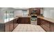 Well-lit kitchen offers stainless steel appliances, wood cabinets, and granite countertops at 8635 Chadwick Dr, Tampa, FL 33635