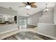 Bright living room with modern flooring, access to the kitchen, and sliding doors to the pool area at 8635 Chadwick Dr, Tampa, FL 33635