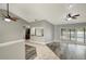 Open living room with modern flooring, ceiling fans, and access to the backyard pool at 8635 Chadwick Dr, Tampa, FL 33635