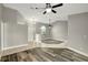 Living room offers neutral paint colors, ceiling fan, and tiled entrance with half-wall at 8635 Chadwick Dr, Tampa, FL 33635