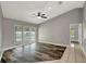 Living room with neutral walls, sleek flooring, and sliding glass doors to the screened-in pool area at 8635 Chadwick Dr, Tampa, FL 33635