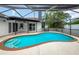 Inviting screened-in pool with multiple entry steps and a view of the blue sky; a perfect backyard oasis at 8635 Chadwick Dr, Tampa, FL 33635