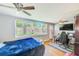 Bedroom with hardwood floors, a large window, a ceiling fan, and a desk at 10436 117Th Dr, Largo, FL 33773