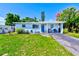 Quaint single-Gathering home with a well-maintained lawn, blue exterior, and a welcoming entrance at 10436 117Th Dr, Largo, FL 33773