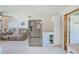 Modern kitchen with stainless steel refrigerator adjacent to open living area with sofa seating at 10436 117Th Dr, Largo, FL 33773