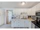 Bright kitchen featuring white cabinets, stainless steel appliances, and ample counter space at 10436 117Th Dr, Largo, FL 33773