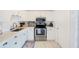 Well-lit kitchen with stainless steel appliances, white cabinets, and an undermount sink at 10436 117Th Dr, Largo, FL 33773