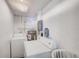 Bright laundry room with a washing machine, dryer, and utility sink at 10436 117Th Dr, Largo, FL 33773