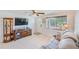Inviting living room boasts tile flooring, a large window, a comfortable sofa, and ample space at 10436 117Th Dr, Largo, FL 33773