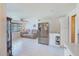 Spacious living room with tile floors flows into a modern kitchen with stainless steel appliances at 10436 117Th Dr, Largo, FL 33773