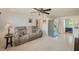 Open-concept living area with tile flooring, a comfortable sofa, and seamless transition to the kitchen at 10436 117Th Dr, Largo, FL 33773