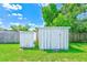 Backyard view of outdoor shed and grassy lawn at 10436 117Th Dr, Largo, FL 33773